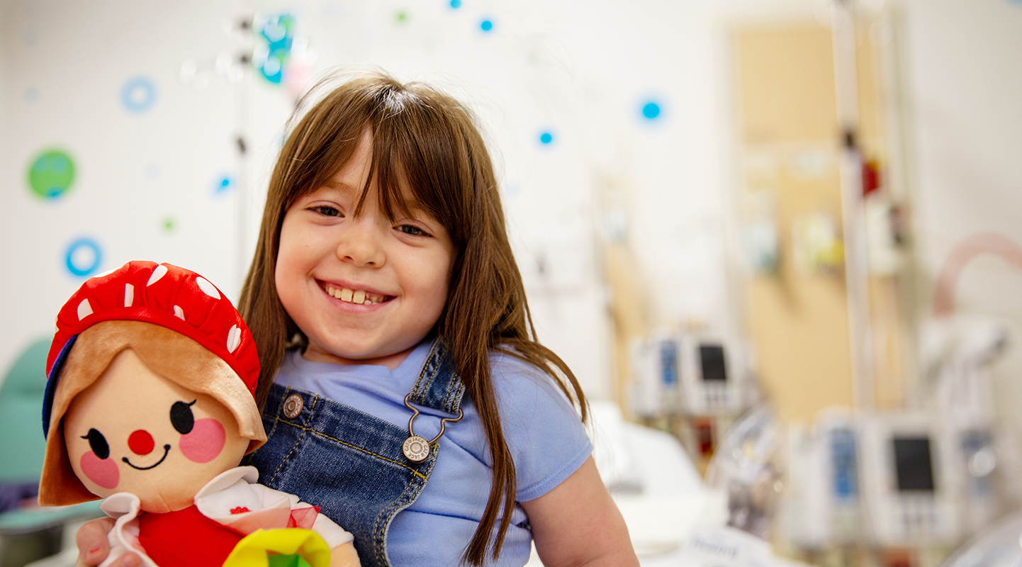 Young patient holding a lotsy dotsy hospital clown dolll