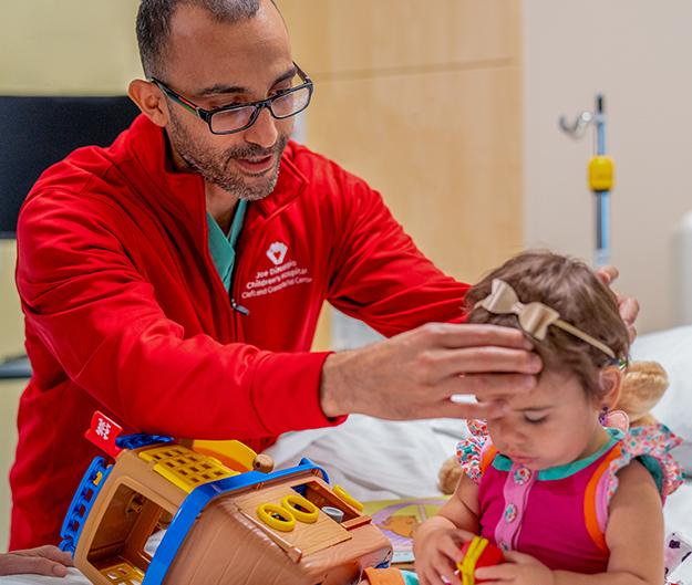 George Kamel, MD, craniofacial surgeon, with Parker, who had choanal atresia and craniosysnostosis